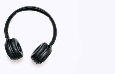 Overhead wireless headphones isolated on white background with free space for text. Close-up of black wireless headphones for playing games and listening to music tracks.