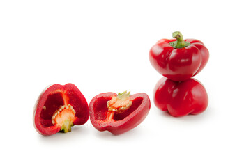 Two whole and halves of red bell pepper isolated on white background with clipping path. .