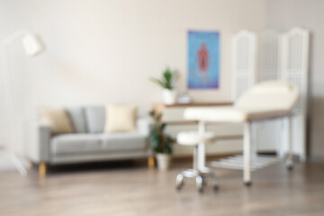 Blurred view of medical office with sofa and couch