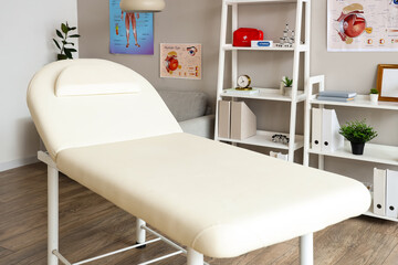 Interior of light medical office with couch and shelf units