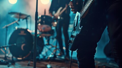 Music band perform on stage, electric guitar, bass guitar and drums, close up on electric guitar