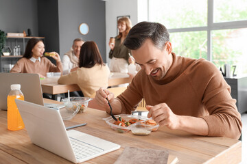 Businessman having lunch in office kitchen