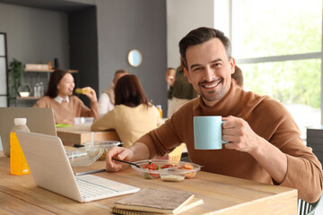 Businessman having lunch in office kitchen