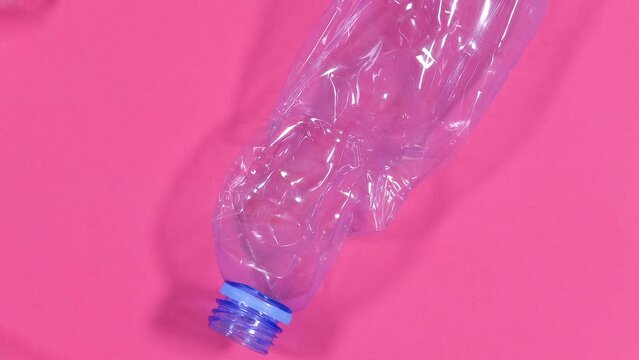 Video background of plastic bottles isolated on pink background. Recycle waste management concept. Plastic Pet Bottles