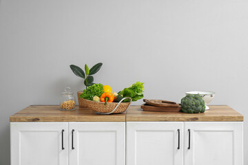 Wooden counter with fresh vegetables in kitchen