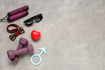 Skipping rope, bow tie, dumbbells, heart and male sign on grey grunge background. Prostate cancer awareness