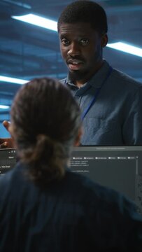 Vertical video Supervisor in server hub workplace managing diverse team of developers looking for equipment software misconfigurations. Manager coordinating professionals mending data center bugs