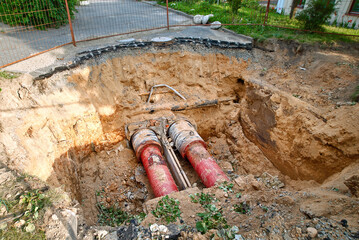 Water pipeline in trench, underground communications at construction site. Water pipeline, pipes...