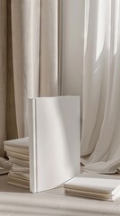 A white book mockup with no text. The cover features white paper texture. 