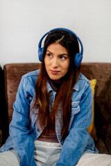  Women listening to Music with Blue Headphones and Denim Jacket