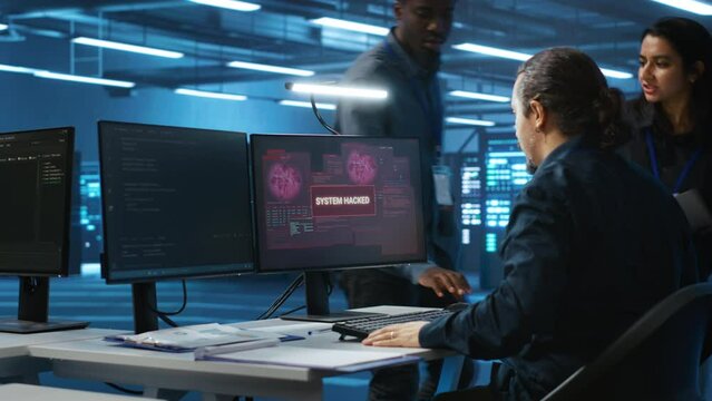 System administrator in server room workplace requesting assistance from colleagues during malware attack. IT support worker asking for help from colleagues to protect data center from hackers