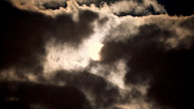NORMAL SPEED VIDEO OF DRAMATIC NIGHT SKY WITH FULL MOON AMONG THE DARK CLOUDS