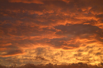 low storm clouds painted in fiery hues at sunset