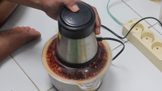 The process of grinding red pepper uses a blender machine to make cooking spices. Capsium annuum L