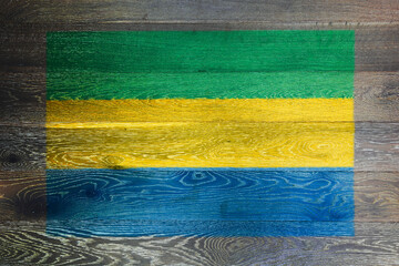 Gabon flag on rustic old wood