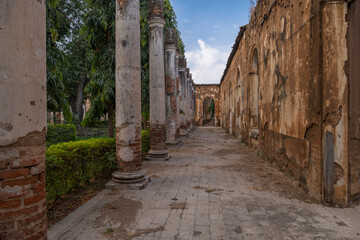 Abandoned old crumbling red brick colonial building. Old school of arts in Santa Ana, El Salvador.