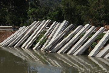 Piles of concrete slabs on the riverbank in Indonesia.