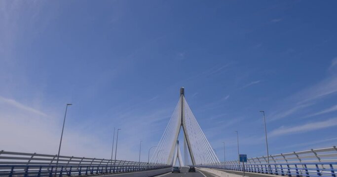Alamillo bridge in Sevilla with cars on road and blue sky tracking shot