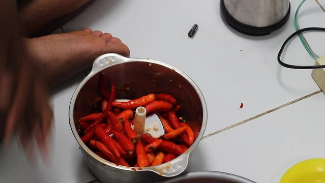 The process of grinding red pepper uses a blender machine to make cooking spices. Capsium annuum L