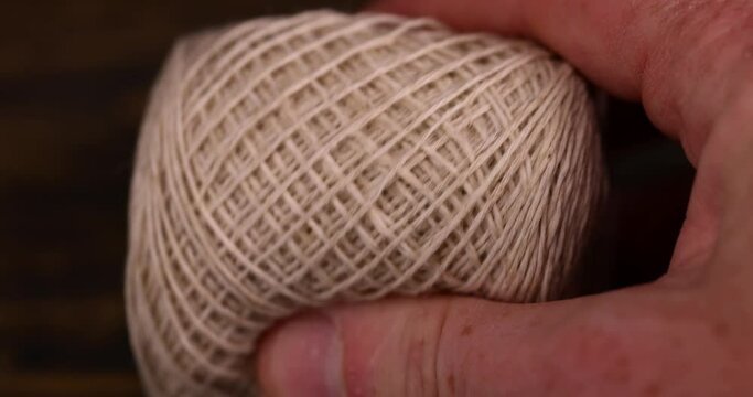 fine cotton thread for knitting and embroidery, close-up of a ball of light-colored thread for needlework