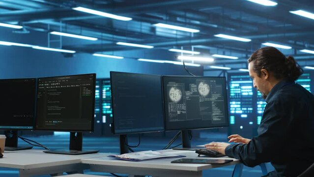 IT technician coding on computer in server farm establishment interrupted by virus attack, running to get help. IT support employee programming on PC rushing to check equipment after hacking attack