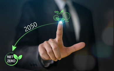 Businessman point at net zero carbon emission target for 2050, sustainability, environmental...