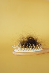 a brush with lost hair on table 