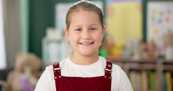 Smile, face and child in school for education, learning and ready for morning kindergarten. Happy, classroom and portrait of girl or student with knowledge, studying and pride for academic lesson