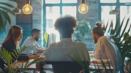 A group of diverse professionals in a modern office are having a meeting and brainstorming ideas. AIG535