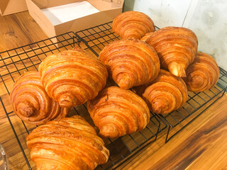 Pile of freshly baked croissants on the tray. French butted croissants in the restaurant.