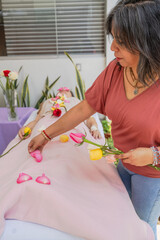 Therapist doing healing with rose petals to her patient