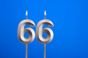 Birthday candle number 66 - Celebration card on blue background