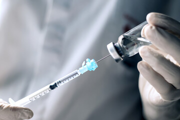 injecting injection vaccine vaccination medicine into a syringe woman nurse