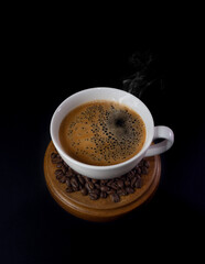 Deliciosa taza de café y granos de café en base de madera
