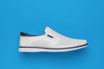 Modern White Slip-On Shoe on Blue Background for Fashion and Footwear Photography