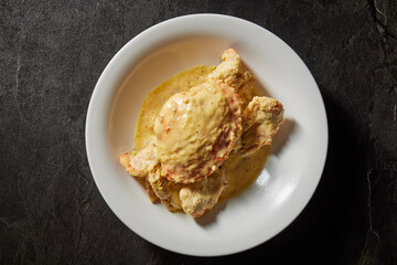 traditional chinese wok fried seafood fresh big meat crab with chilli spicy salted egg yolk cheese cream sauce in plate on dark stone table asian cafe hotel luxury halal food restaurant banquet menu