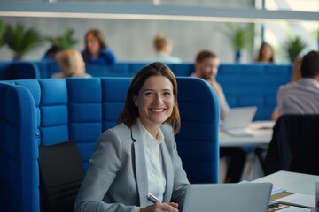 Young successful businesswoman at corporate office looking at camera. Office business portrait