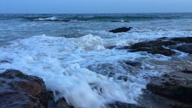 Waves crashing on rocks at Visakhapatnam beach