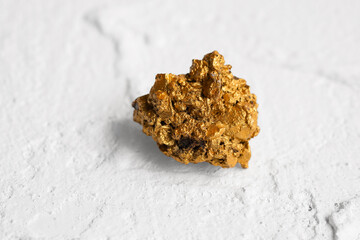 Gold ore lump from mine on white background
