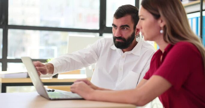 Business team discussing work on laptop