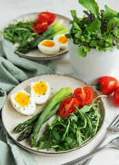 Fresh Spring Salad With Boiled Eggs, Asparagus, and Tomatoes on a Bright Day