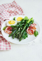 Fresh Asparagus and Prosciutto Salad Served With Boiled Eggs and Microgreens
