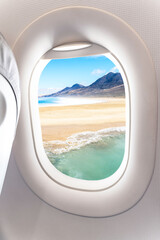 Beautiful view of a tropical beach from the airplane window. - Summer vacation concept.
