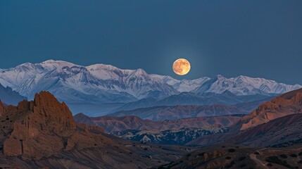 A photo capturing the full moon shining over the majestic Atlas Mountains.
