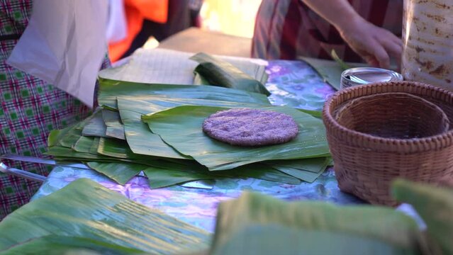 Grilling sticky rice with sesame sesame local Shan Tai yai food Chiangmai Thailand Southeast Asia banana leaf package
