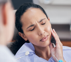 Woman, toothache and pain at dentist for consultation with discussion, problem and tooth injury for...