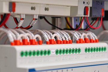 Connection of electrical wires to electronic control modules in an electrical distribution cabinet.