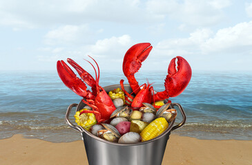Lobster Bake on the beach as a Pot of lobsters boiling with corn clams and potatoes as a classic...