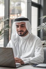 Arab man working on laptop in office
