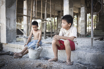 Poor children at the construction site were forced to work. Concept against child labor. The oppression or intimidation of forced labor among children. Human trafficking.